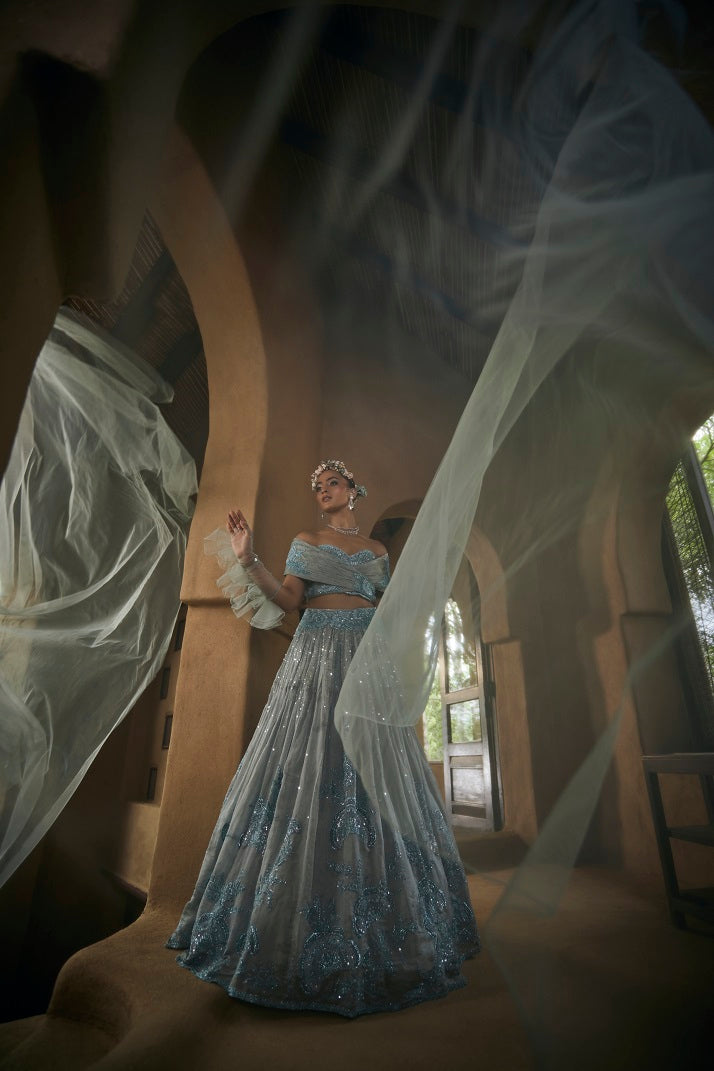 Powder blue silk tissue lehnga set with busiter blouse and overlap cape
