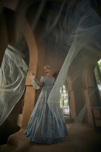 Powder blue silk tissue lehnga set with busiter blouse and overlap cape