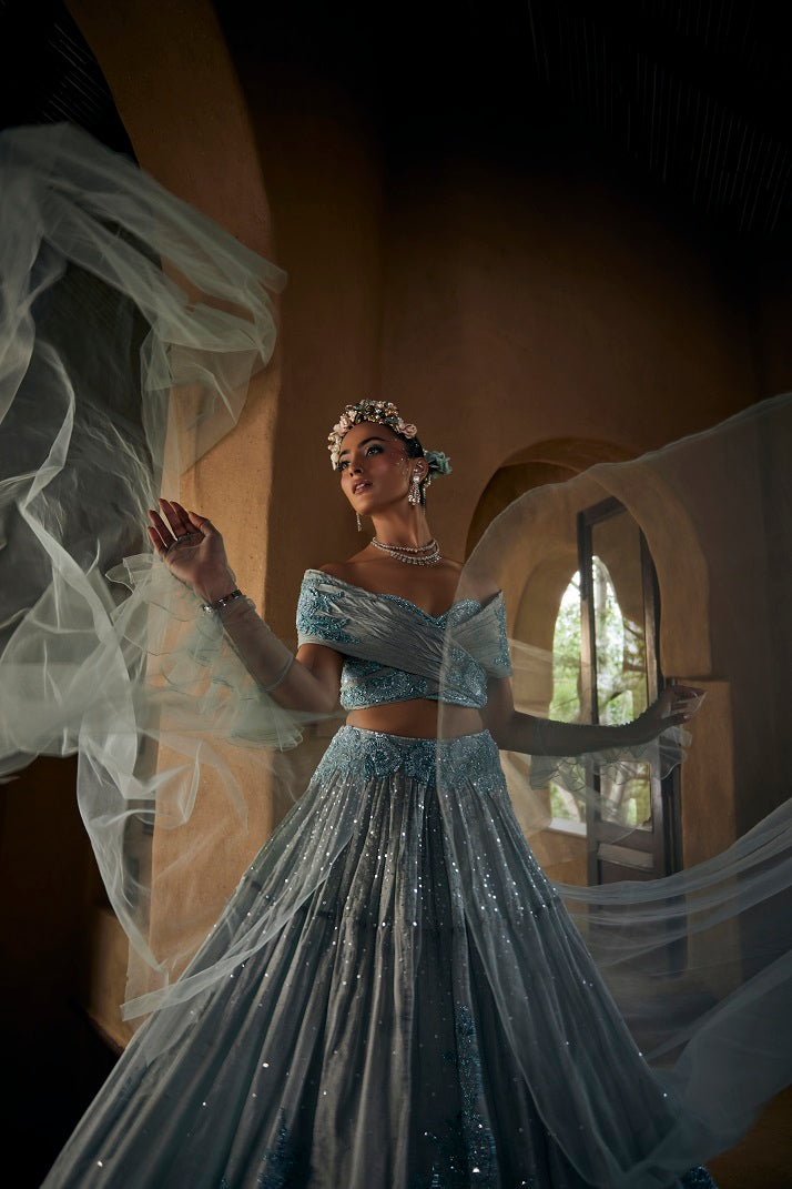 Powder blue silk tissue lehnga set with busiter blouse and overlap cape