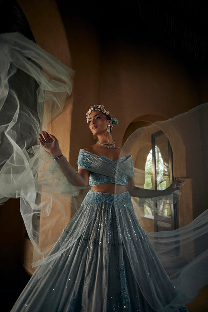 Powder blue silk tissue lehnga set with busiter blouse and overlap cape