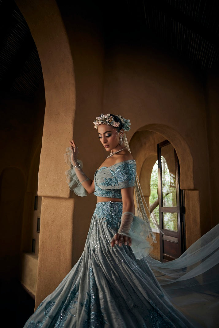 Powder blue silk tissue lehnga set with busiter blouse and overlap cape