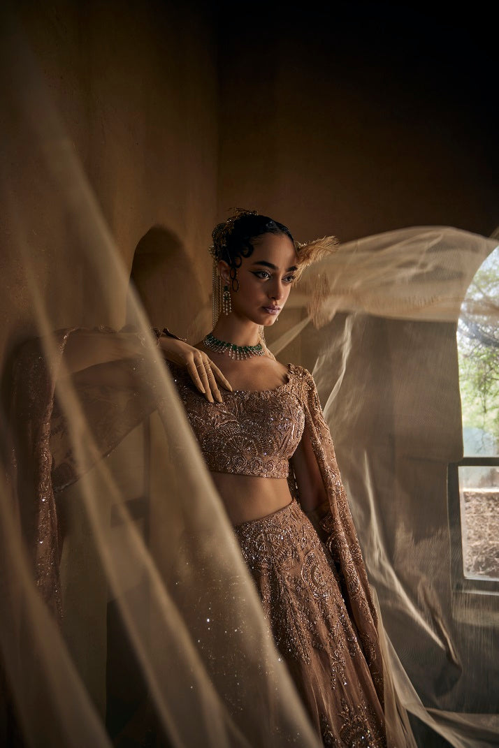 Dusty gold silk tissue lehnga set with cape sleeve blouse